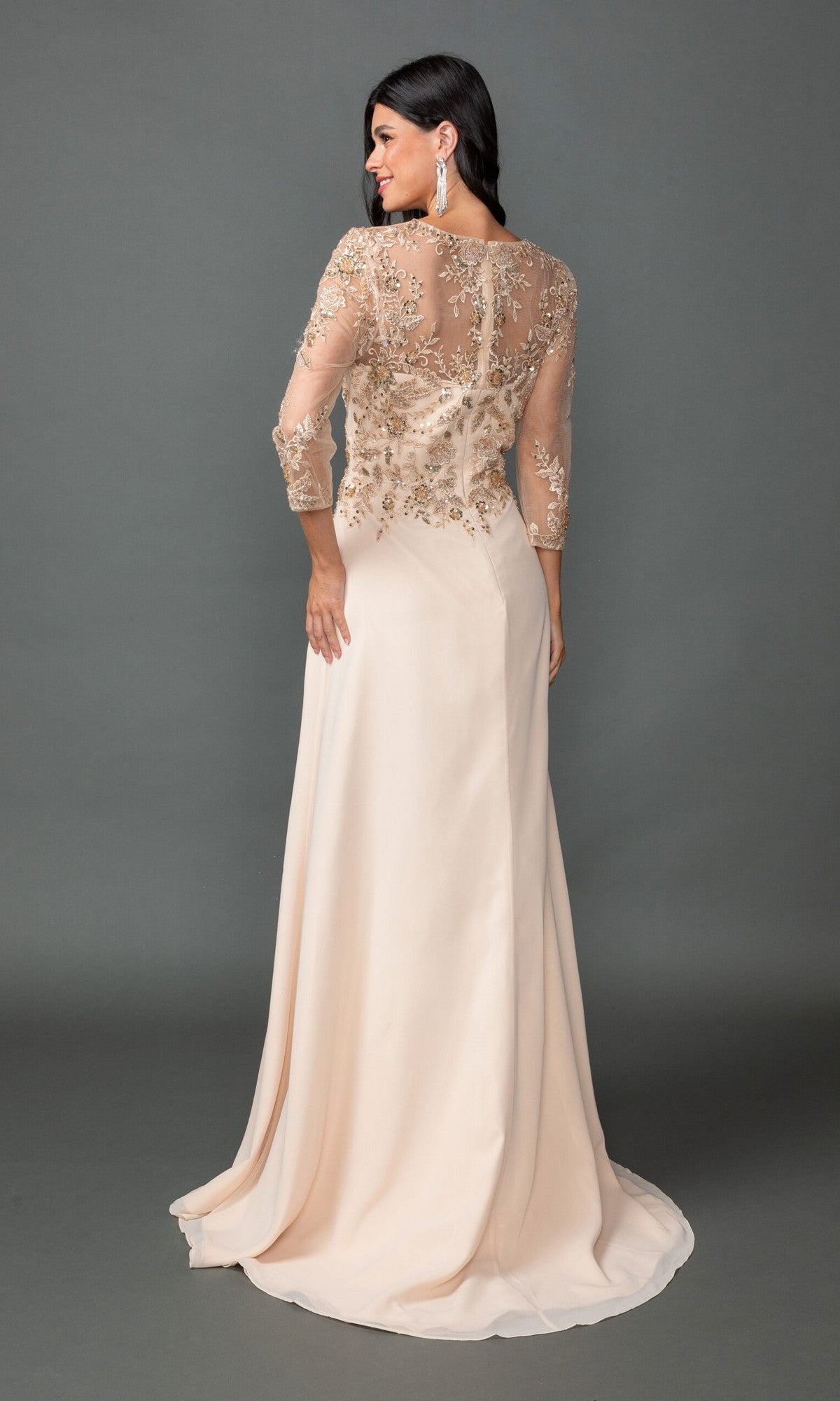 A woman stands with her back to the camera wearing the Dancing Queen 4543 long formal dress, featuring a cream hue, sheer embellished sleeves and back, a sequin lace bodice, and an elegant A-line skirt against a gray backdrop.